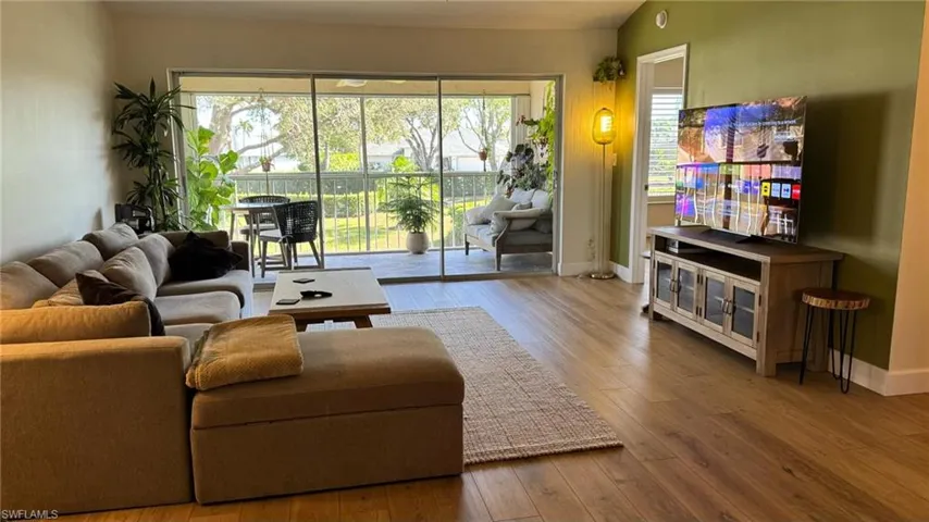 Living room featuring hardwood / wood-style flooring and lofted ceiling