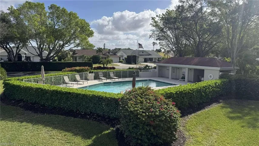 View of swimming pool featuring a lawn and a pool deck