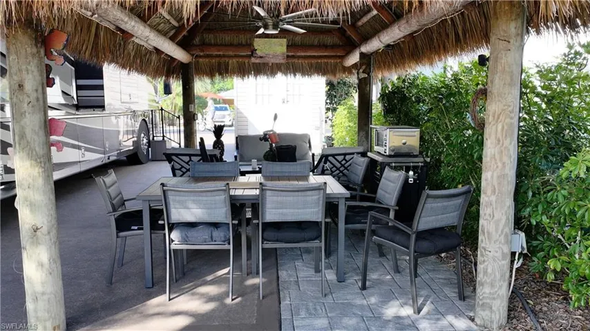 View of patio / terrace featuring ceiling fan, a gazebo, and outdoor dining area