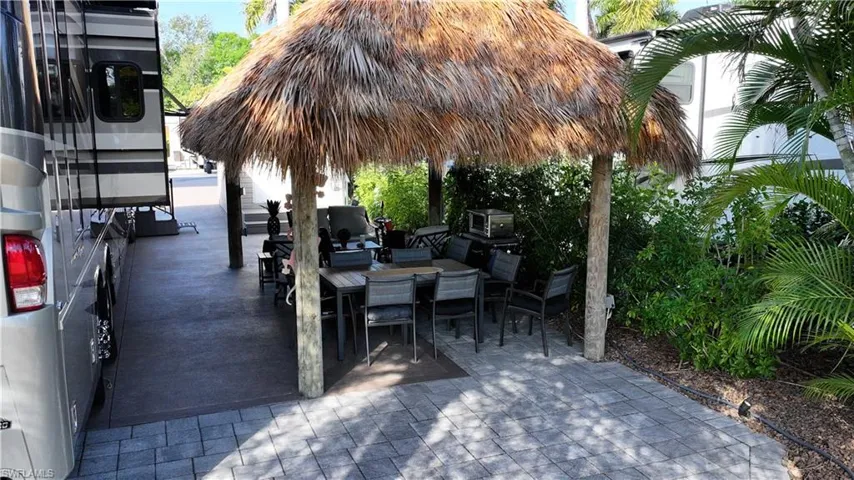 View of patio featuring outdoor dining space and a gazebo