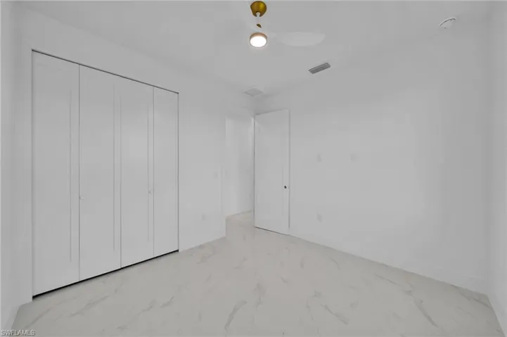 Unfurnished bedroom featuring a closet and ceiling fan