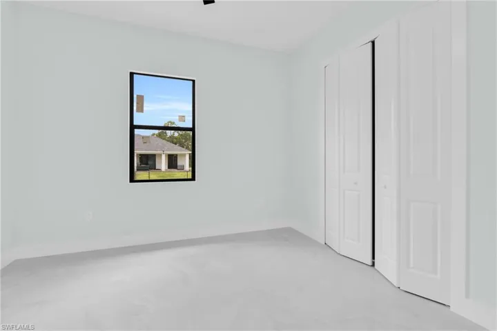 Unfurnished bedroom featuring a closet and baseboards