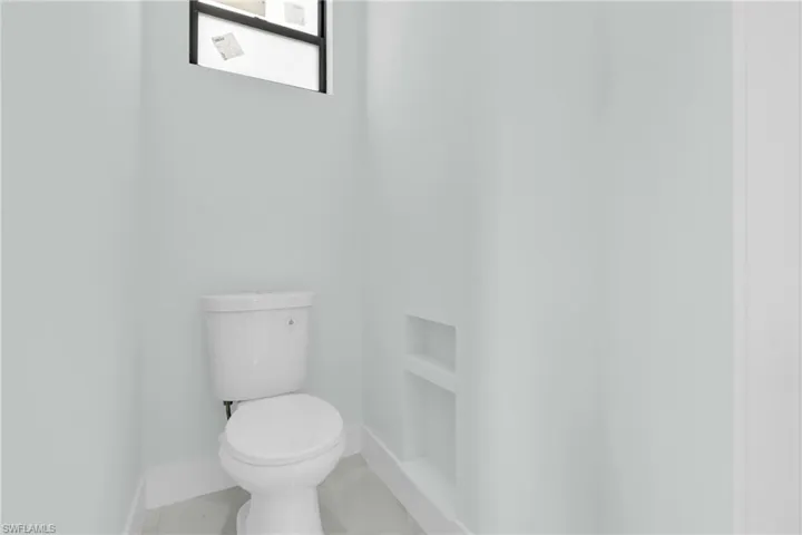 Bathroom featuring toilet and baseboards