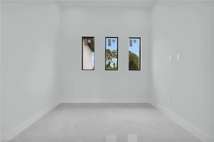 Unfurnished room with baseboards and light marble finish flooring