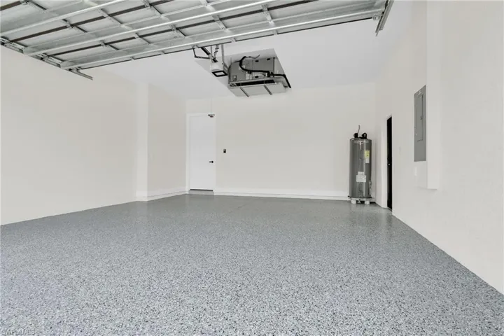 Garage with water heater and a garage door opener