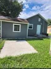 Back of property with a yard and a patio area