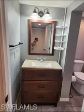 Bathroom featuring vanity, toilet, and tile patterned flooring