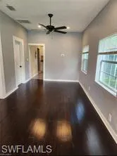 Spare room with ceiling fan and dark hardwood / wood-style flooring