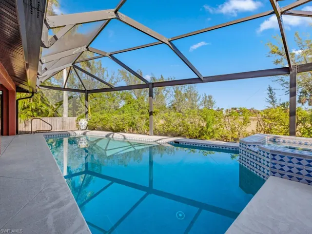 View of swimming pool featuring a lanai and a patio