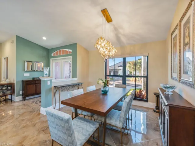 Dining room with lofted ceiling and an inviting chandelier