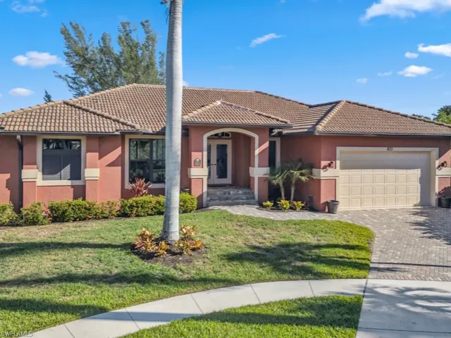 View of front of home with a garage and a front lawn