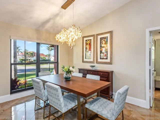 Dining space with lofted ceiling and a notable chandelier