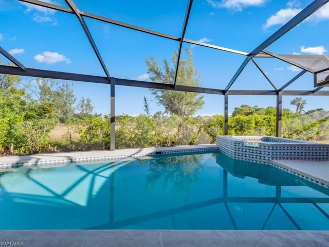 View of pool with glass enclosure