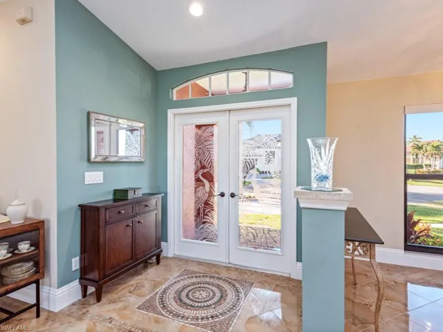 Foyer featuring vaulted ceiling and french doors