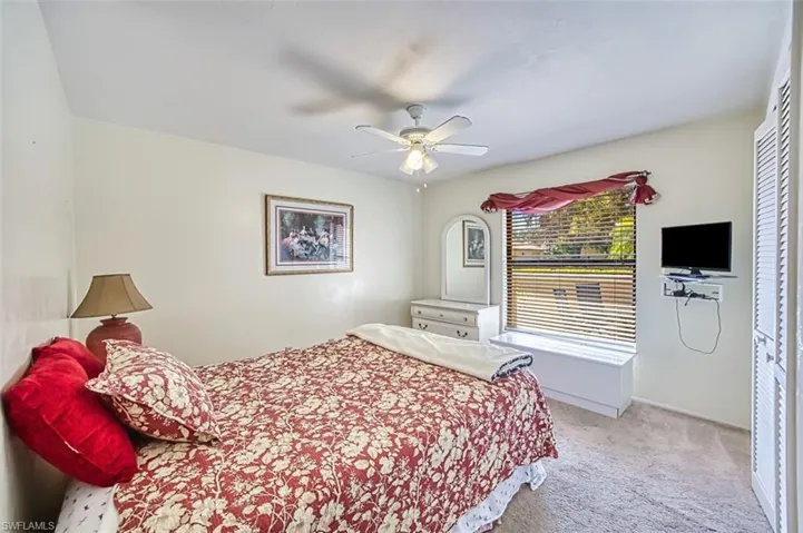 Bedroom featuring light colored carpet and a ceiling fan