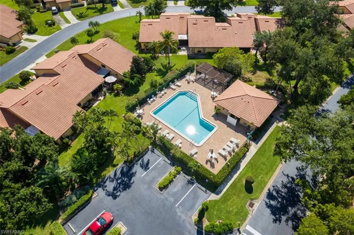 Aerial view of residential area featuring a pool area