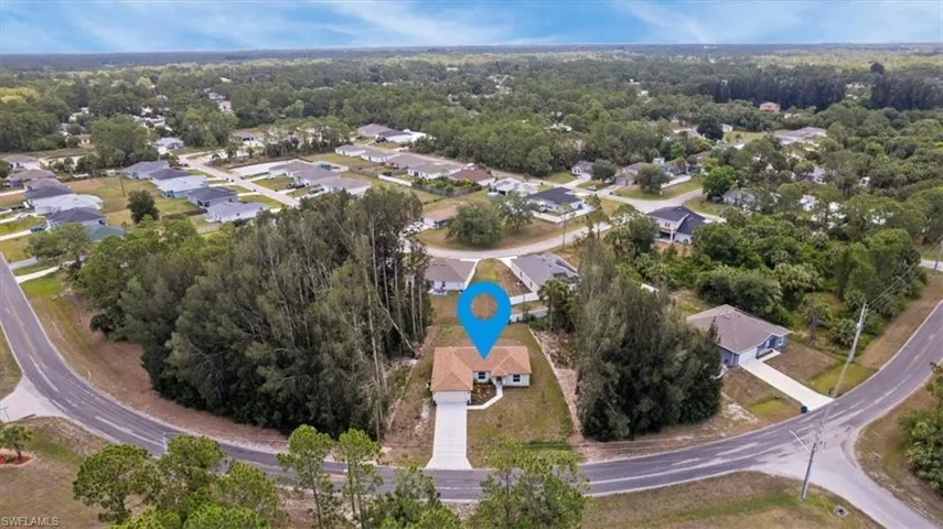 Aerial view of property and surrounding area with nearby suburban area
