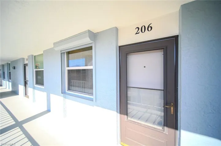 Front Entry Into Unit With Storm Shutters Over Window!