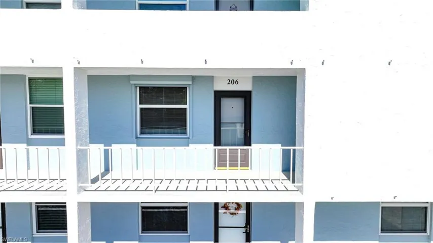 Aerial View Of Balcony And Front Door And Window With Shutters!