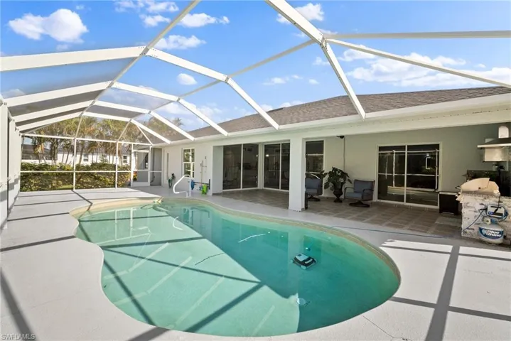 Swimming pool with a patio, a lanai, and grilling area