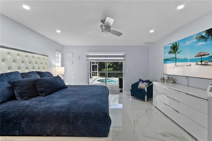 Bedroom with light marble finish flooring, access to exterior, recessed lighting, and ceiling fan