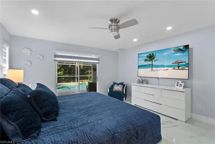 Bedroom featuring access to exterior, light marble finish flooring, recessed lighting, and ceiling fan