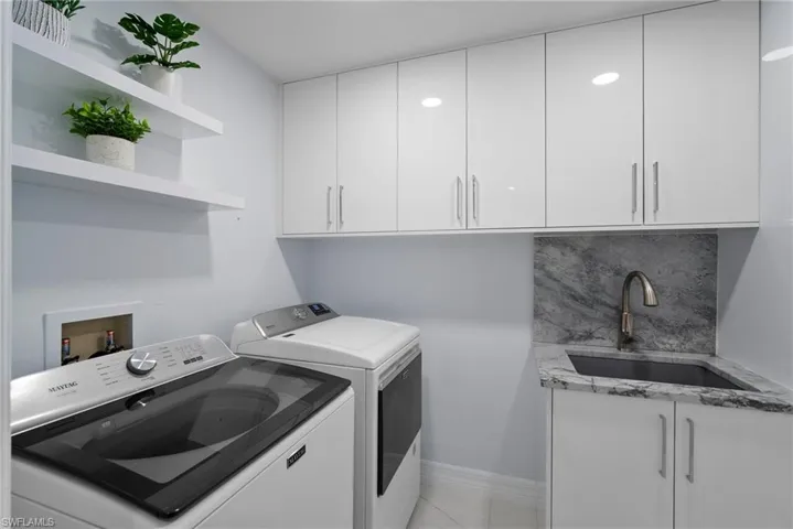 Laundry room with washing machine and clothes dryer and cabinet space