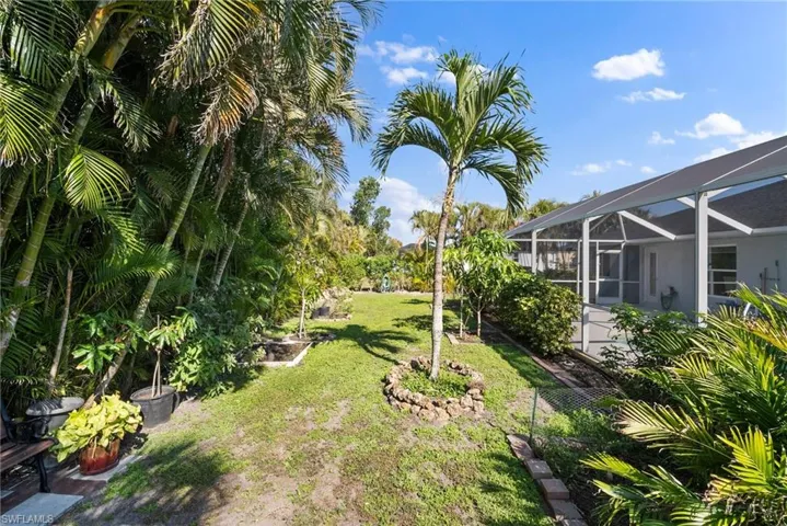 View of grassy yard with a lanai