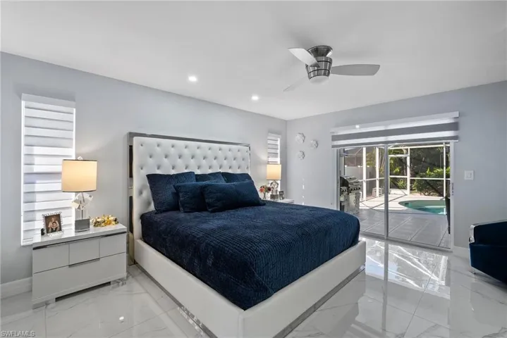 Bedroom with access to exterior, light marble finish floors, recessed lighting, and ceiling fan