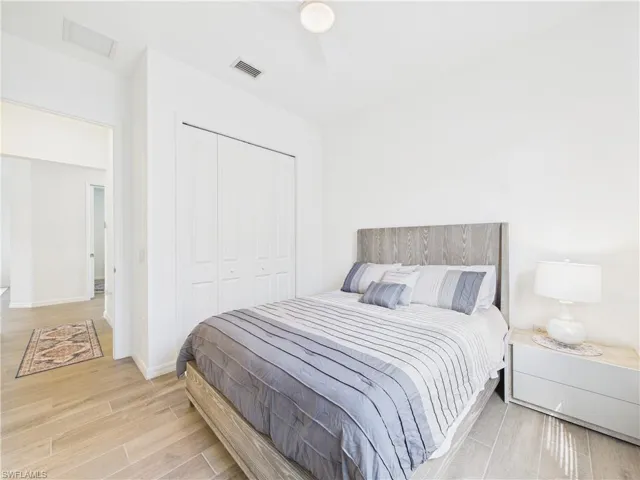 Bedroom featuring a closet, light wood finished floors, and ceiling fan