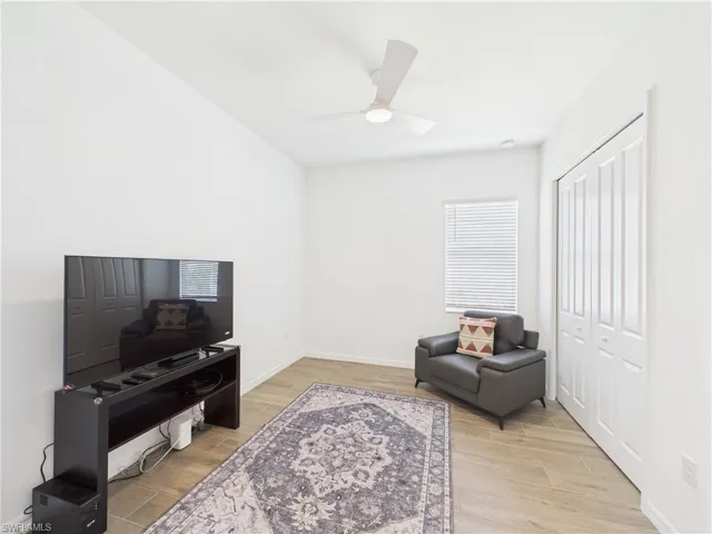 Sitting room featuring light wood finished floors and a ceiling fan