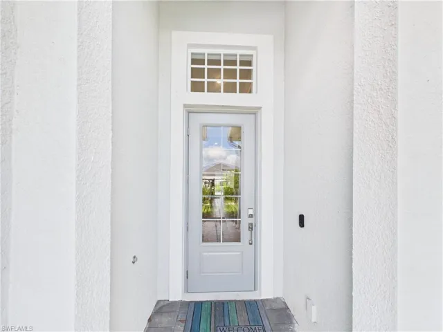 Property entrance with stucco siding