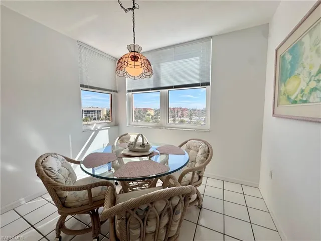 Dining room featuring light tile patterned floors with great natural light