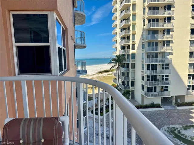 Balcony featuring view of beach