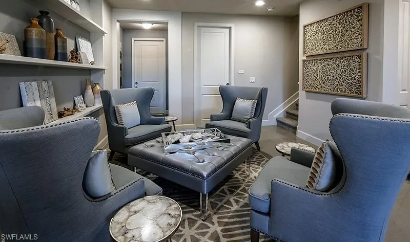 Living area with stairway and recessed lighting