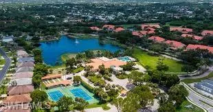 Aerial perspective of suburban area featuring a large body of water