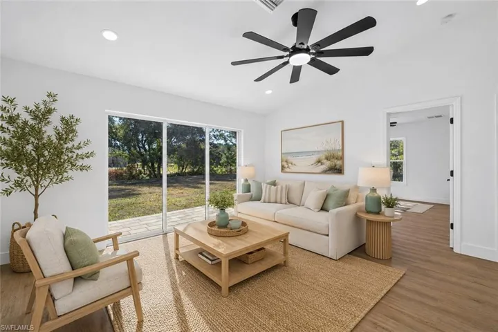 Living Room with Vaulted Ceilings & Large Modern Fan