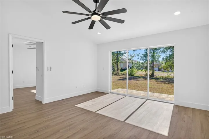 Living Room with Vaulted Ceilings & Large Modern Fan