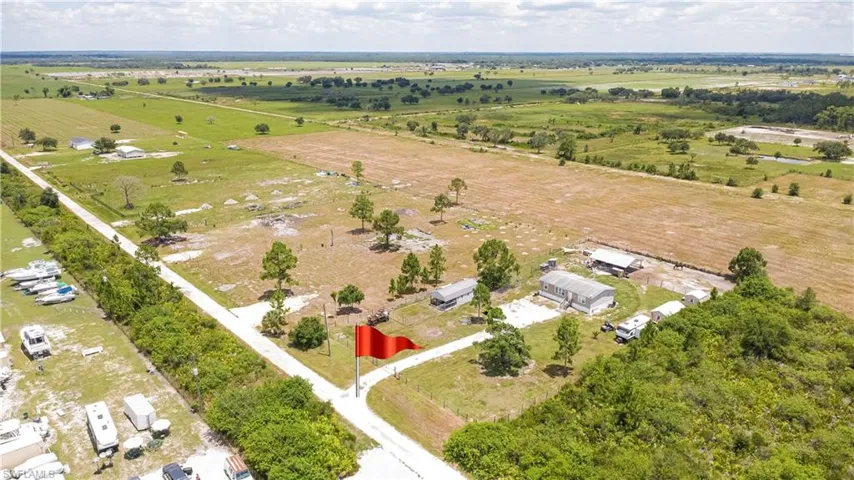 Expansive parcel featuring a main structure, outbuildings, and multiple clearings