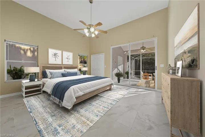 Bedroom with access to exterior, a high ceiling, and ceiling fan