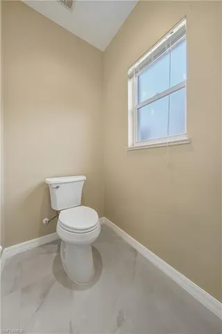 Bathroom with marble look tile flooring