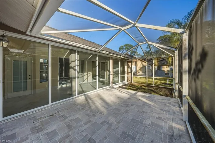 Unfurnished sunroom with a patio area