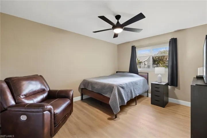 This simple yet spacious guest bedroom has enough room for a king-size bed, nightstands, and a dresser. It also features luxury vinyl flooring and impact windows.