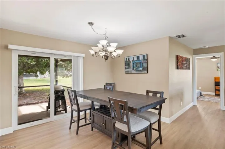 The dining are is simple, clean, and casual, creating a comfortable and functional area with warm and inviting lighting and a cohesive color palette.