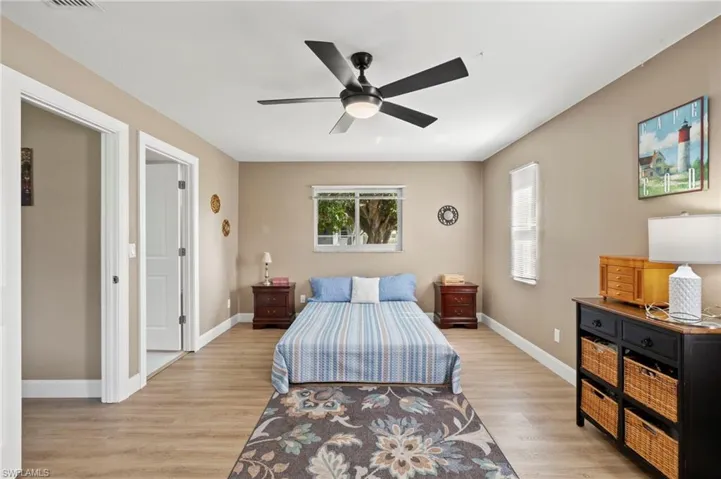 Primary Bedroom with luxury Vinyl flooring, a closet, and multiple impact windows allowing abundant natural light.