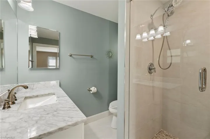The bathroom has been updated with a new vanity, a new shower complete with shower doors, and a new toilet.