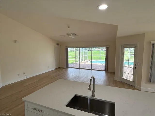 Kitchen with view of the living room as well as swimming pool