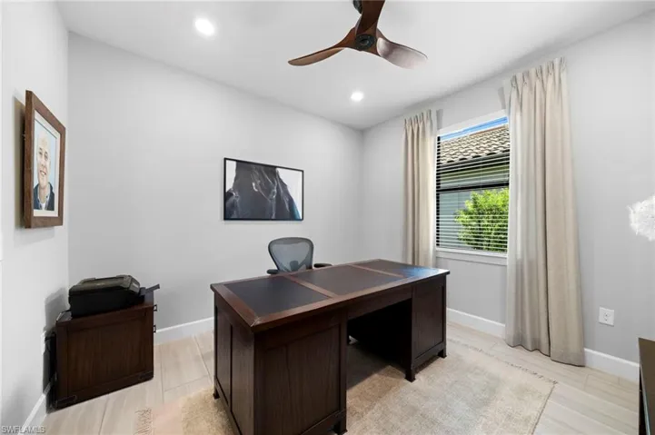 Office area featuring light wood-style flooring, recessed lighting, and ceiling fan