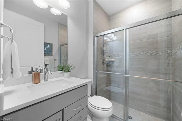 Full bath with vanity and a shower stall