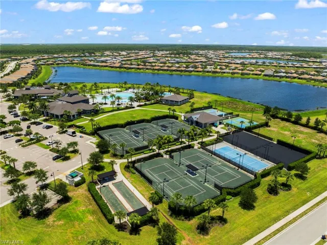 Aerial view of residential area with a nearby body of water and a pool area